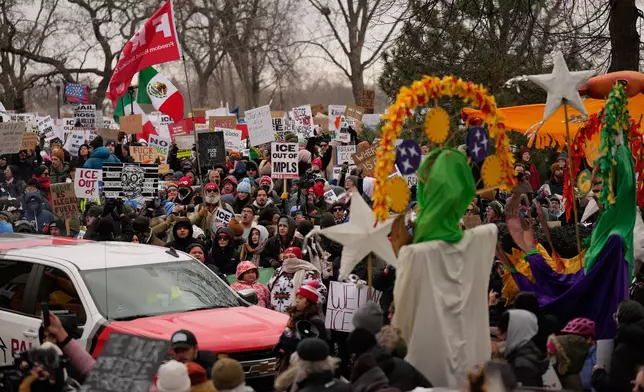 Protesters gather during a rally for Renee Good, who was fatally shot by an ICE officer earlier in the week, Saturday, Jan. 10, 2026, in Minneapolis. (AP Photo/John Locher)