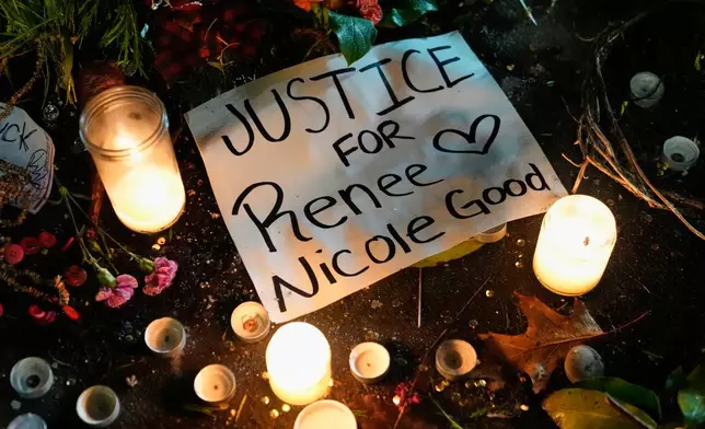 A sign for Renee Good, who was fatally shot by an ICE officer in Minneapolis earlier in the week, is seen on the ground alongside candles as people gather outside the U.S. Immigration and Customs Enforcement facility Friday, Jan. 9, 2026, in Portland, Ore. (AP Photo/Jenny Kane)