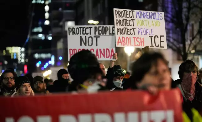 People march to the U.S. Immigration and Customs Enforcement facility in honor of victims of ICE shootings Friday, Jan. 9, 2026, in Portland, Ore. (AP Photo/Jenny Kane)