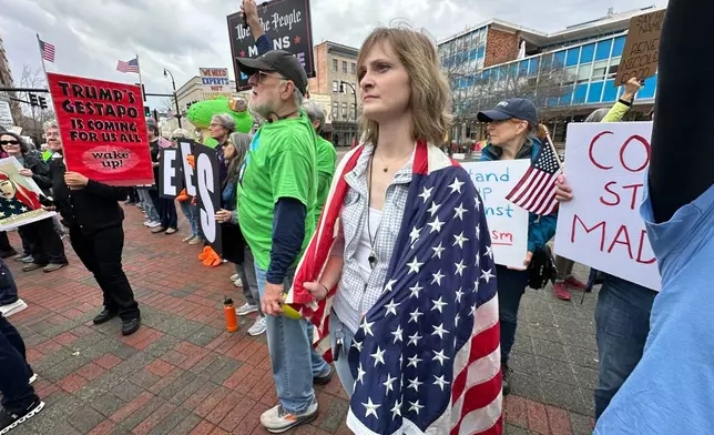 People gather during a protest on Saturday, Jan. 10, 2026 in downtown Durham, NC. (AP Photo/Allen G. Breed)