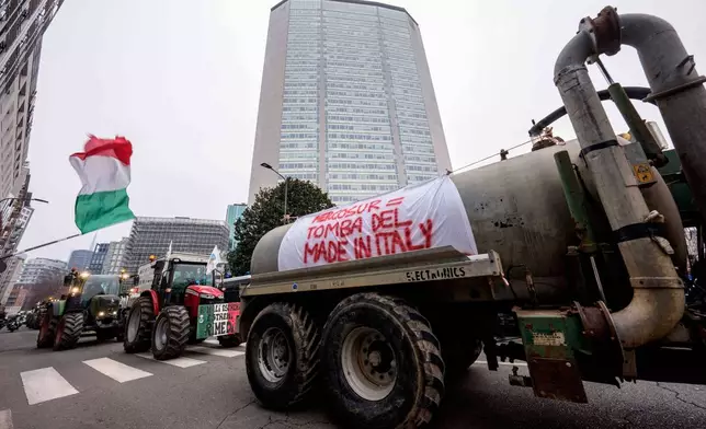 A banner with writing in Italian "Mercusur, the tomb of made in Italy" hangs from a truck during a farmers protest against the Mercosur deal, a free trade deal between the European Union and five South American nations, in Milan, Italy, Friday, Jan. 9, 2026. (Claudio Furlan/LaPresse via AP)