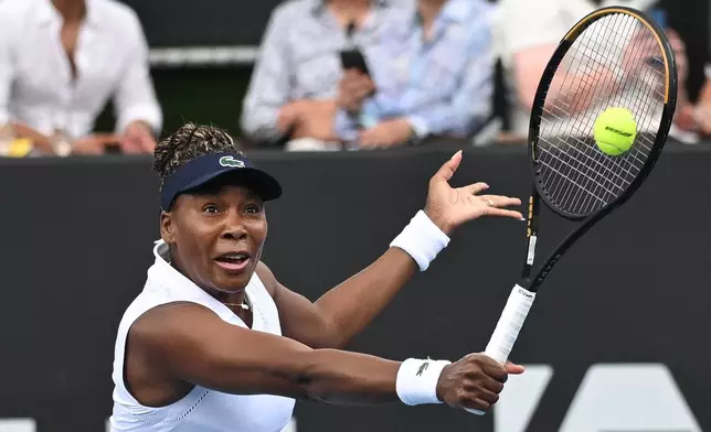 Venus Williams of the U.S. hits a backhand to Magda Linette of Poland during her singles match of the ASB Classic Women's Tennis Tournament in Auckland, New Zealand, Tuesday Jan. 6, 2026. (Andrew Cornaga/Photosport via AP)