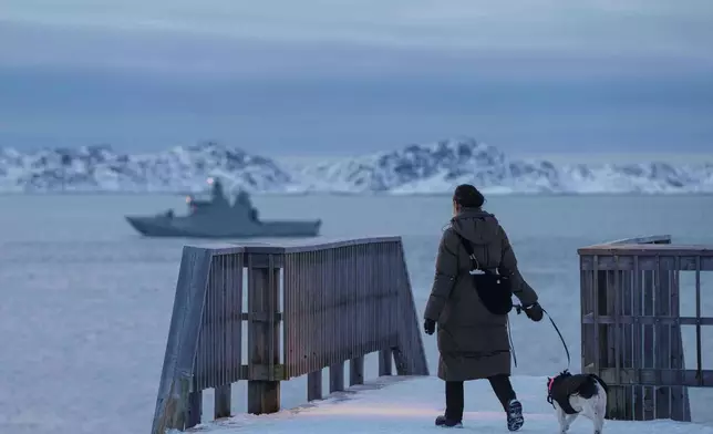 A woman walks with her dog in Nuuk, Greenland, on Thursday, Jan. 15, 2026. (AP Photo/Evgeniy Maloletka)