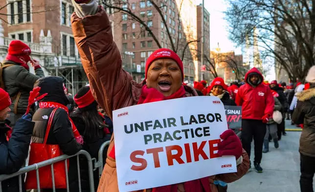 Members of the New York State Nurses Association union picket outside Mount Sinai West Hospital, Tuesday, Jan. 20, 2026, in New York. (AP Photo/Ryan Murphy)