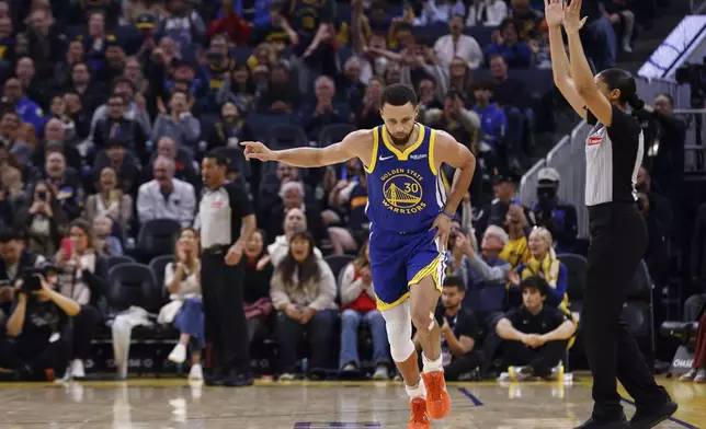 Golden State Warriors guard Stephen Curry (30) celebrates his three-pointer against the Utah Jazz in the first quarter during an NBA basketball game in San Francisco, Saturday, Jan. 3, 2026. (Santiago Mejia/San Francisco Chronicle via AP)