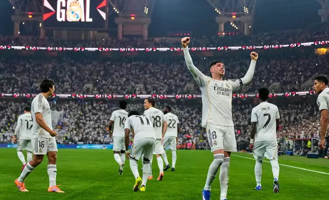 Real Madrid's Federico Valverde, foreground, celebrates after scoring the opening goal during the Spanish Super Cup semifinal soccer match against Atletico Madrid at King Abdullah Sports City Stadium in Jeddah, Saudi Arabia, Thursday, Jan. 8, 2026. (AP Photo/Altaf Qadri)