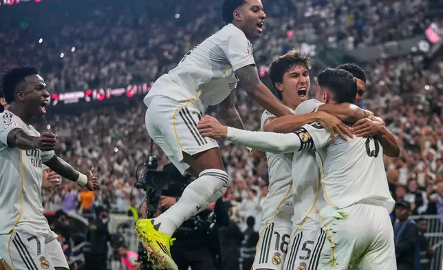 Real Madrid players celebrate after scoring the opening goal during the Spanish Super Cup semifinal soccer match against Atletico Madrid at King Abdullah Sports City Stadium in Jeddah, Saudi Arabia, Thursday, Jan. 8, 2026. (AP Photo/Altaf Qadri)