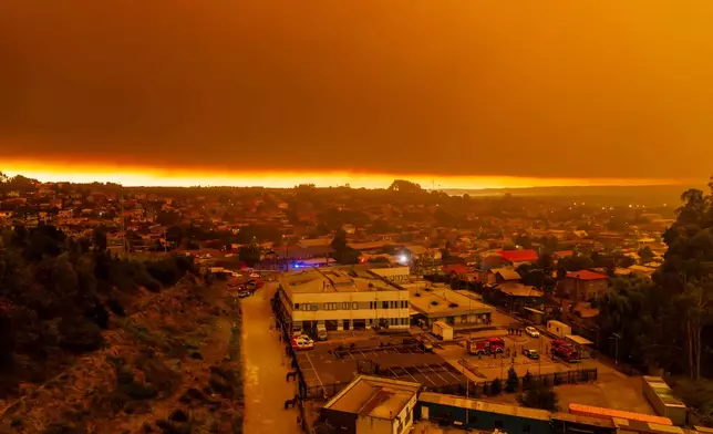 Wildfires burn at sunrise near Lirquen, Chile, Sunday, Jan. 18, 2026. (AP Photo/Javier Torres)
