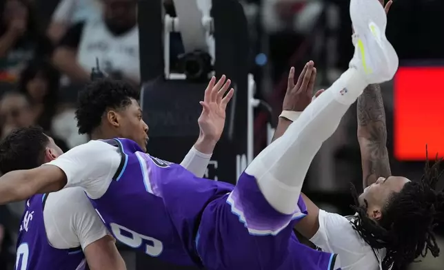 San Antonio Spurs guard Stephon Castle (5) is fouled by Utah Jazz guard Ace Bailey (19) as he drives to the basket during the second half of an NBA basketball game in San Antonio, Monday, Jan. 19, 2026. (AP Photo/Eric Gay)