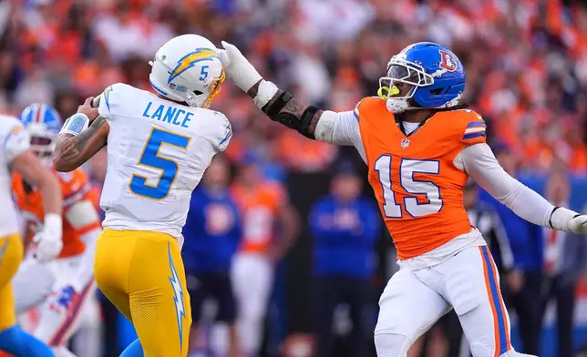 Denver Broncos linebacker Nik Bonitto (15) pressures Los Angeles Chargers quarterback Trey Lance (5) during the first half of an NFL football game, Sunday, Jan. 4, 2026, in Denver. (AP Photo/David Zalubowski)