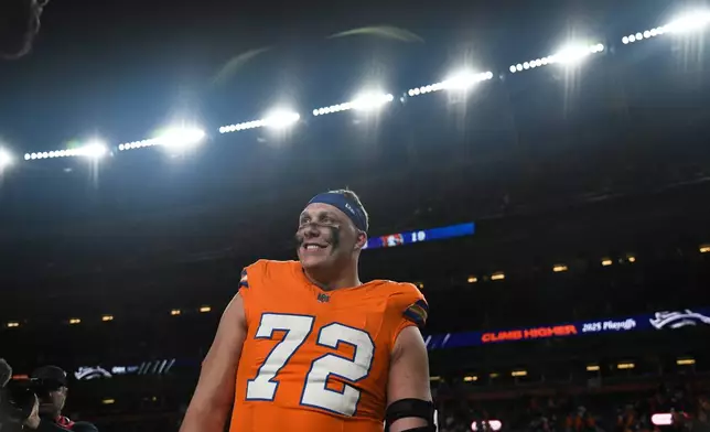 Denver Broncos offensive tackle Garett Bolles smiles as he walks off the field after his team defeated the Los Angeles Chargers in an NFL football game Sunday, Jan. 4, 2026, in Denver. (AP Photo/Eric Lutzens)