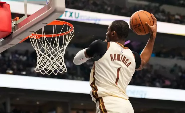 Golden State Warriors forward Jonathan Kuminga (1) winds up to dunk in the first half of an NBA basketball game against the Dallas Mavericks in Dallas, Thursday, Jan. 22, 2026. (AP Photo/Tony Gutierrez)