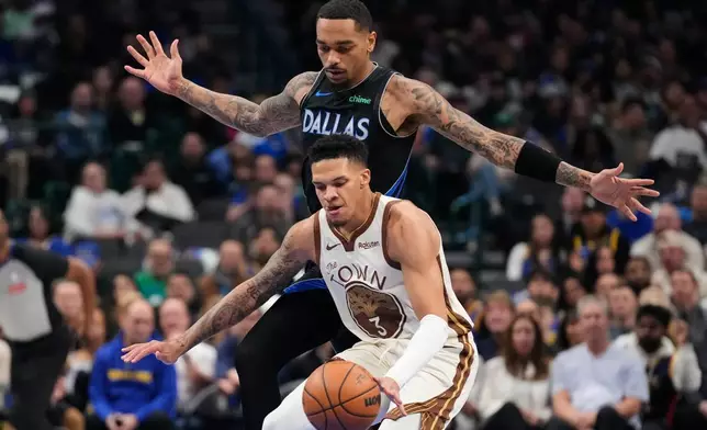 Golden State Warriors guard Will Richard (3) takes control of the ball under pressure from Dallas Mavericks forward P.J. Washington (25) in the first half of an NBA basketball game in Dallas, Thursday, Jan. 22, 2026. (AP Photo/Tony Gutierrez)