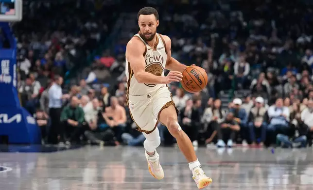 Golden State Warriors guard Stephen Curry works against the Dallas Mavericks in the first half of an NBA basketball game in Dallas, Thursday, Jan. 22, 2026. (AP Photo/Tony Gutierrez)