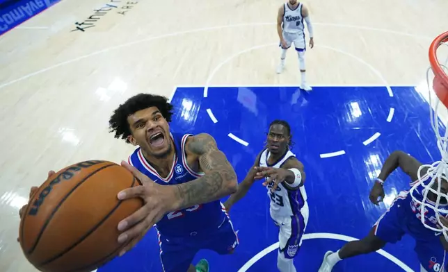 Philadelphia 76ers' Dominick Barlow, left goes up for a shot past Sacramento Kings' Keon Ellis during the first half of an NBA basketball game Thursday, Jan. 29, 2026, in Philadelphia. (AP Photo/Matt Slocum)