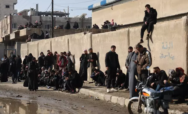 Syrian families wait outside the courthouse for the release of their children who were held at al-Aqtan prison by retreating Syrian Democratic Forces (SDF) in Raqqa, Syria, Sunday, Jan. 25, 2026. (AP Photo/Ghaith Alsayed)