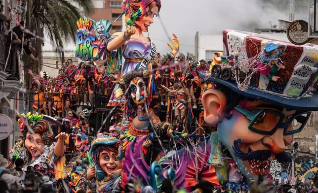 Revelers parade through the streets during the Black and White Carnival, recognized by UNESCO as Intangible Cultural Heritage, in Pasto, Colombia, Tuesday, Jan. 6, 2026. (AP Photo/Ivan Valencia)