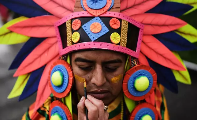 A reveler prepares for the Black and White Carnival, recognized by UNESCO as Intangible Cultural Heritage, in Pasto, Colombia, Tuesday, Jan. 6, 2026. (AP Photo/Ivan Valencia)