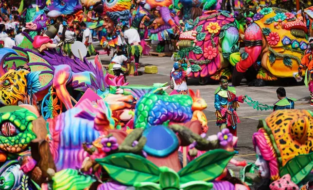 Revelers get ready for the start of the Black and White Carnival, recognized by UNESCO as Intangible Cultural Heritage, in Pasto, Colombia, Tuesday, Jan. 6, 2026. (AP Photo/Ivan Valencia)