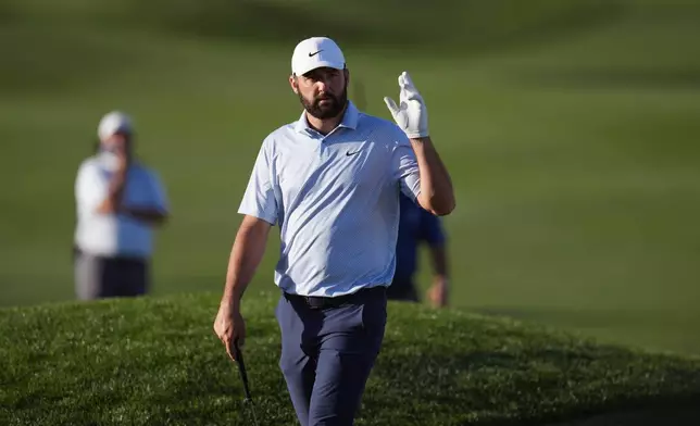 Scottie Scheffler waves to the cheering crowd as he walks to the 18th green during the final round of the American Express golf event on the Pete Dye Stadium Course at PGA West Sunday, Jan. 25, 2026, in La Quinta, Calif. (AP Photo/Ross D. Franklin)
