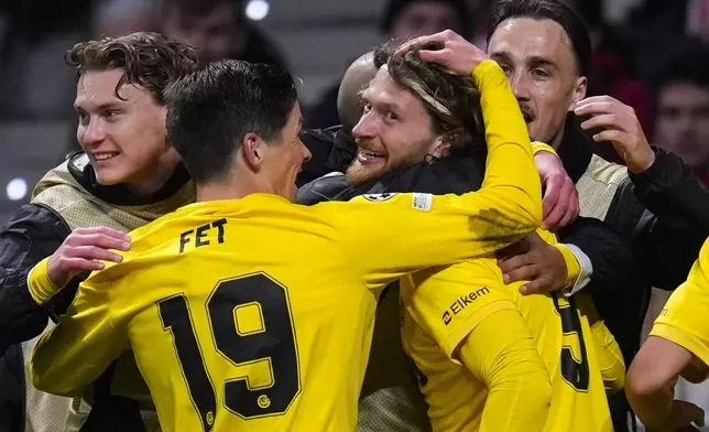 Glimt's Kasper Hogh, center, celebrates after scoring his side's second goal during the Champions League opening phase soccer match between Atletico Madrid and Bodo Glimt in Madrid, Spain, Wednesday, Jan. 28, 2026. (AP Photo/Manu Fernandez)