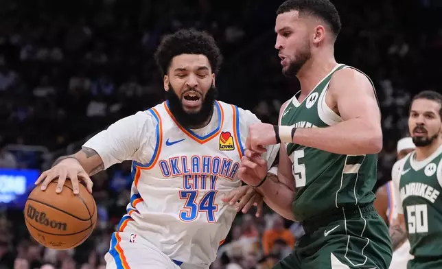 Oklahoma City Thunder's Kenrich Williams tried to get past Milwaukee Bucks' Pete Nance during the first half of an NBA basketball game Wednesday, Jan. 21, 2026, in Milwaukee. (AP Photo/Morry Gash)
