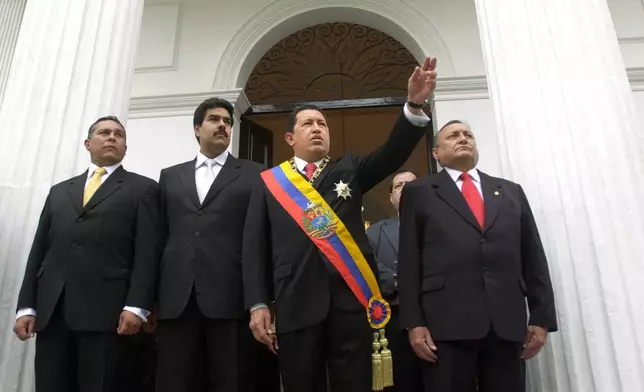 FILE - Venezuelan President Hugo Chavez, center right, is accompanied by President of Congress Nicolas Maduro, center left, before giving his annual speech to Congress in Caracas, Venezuela, Jan. 14, 2005. (AP Photo/Leslie Mazoch, File)
