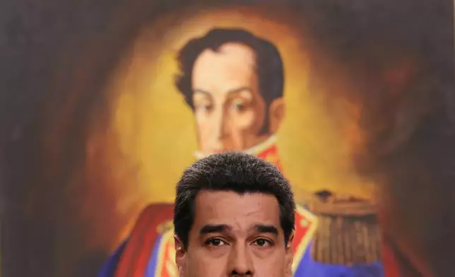 FILE - Venezuela's President Nicolas Maduro, backdropped by a painting of independence hero Simon Bolivar, speaks during a press conference at the Miraflores Presidential Palace in Caracas, Venezuela. (AP Photo/Ariana Cubillos, File)