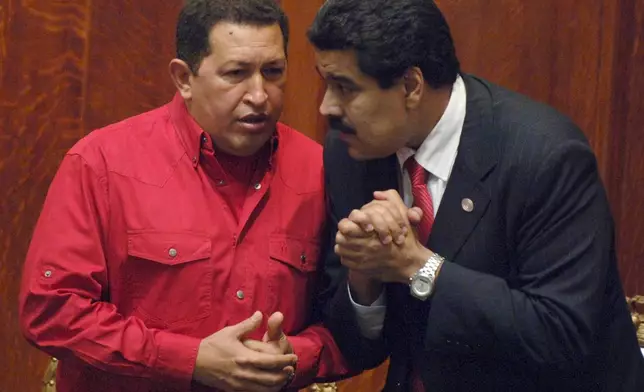FILE - Venezuela's President Hugo Chavez, left, talks to then Foreign Minister Nicolas Maduro in Montevideo, Uruguay, Dec. 18, 2007. (AP Photo/Matilde Campodonico, File)