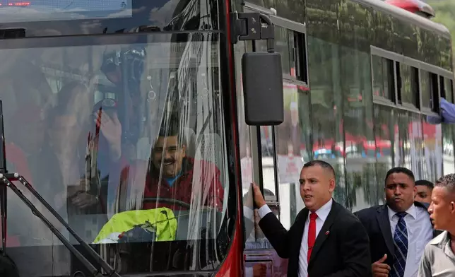 FILE - Venezuela's President Nicolas Maduro arrives at the Miraflores Palace, driving a bus from the airport after returning home from a two-week fundraising trip, in Caracas, Venezuela, Jan. 17, 2015. (AP Photo/Ariana Cubillos, File)