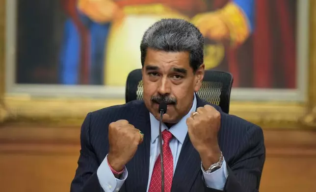 FILE - Venezuelan President Nicolas Maduro raises up his closed fists during a news conference at Miraflores presidential palace in Caracas, Venezuela, July 31, 2024, three days after his disputed reelection. (AP Photo/Matias Delacroix, File)
