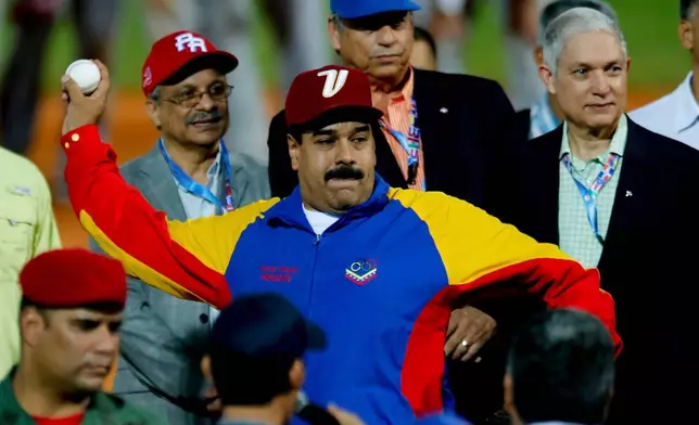 FILE - Venezuela's President Nicolas Maduro winds up to pitch a ball during the opening ceremony of the Caribbean Series baseball tournament in Porlamar, Venezuela, Feb. 1, 2014. (AP Photo/Fernando Llano, File)