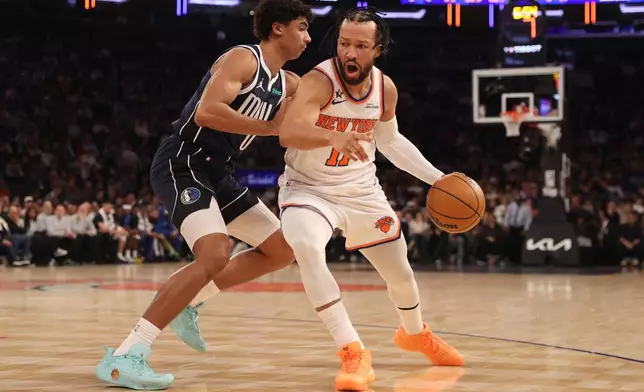 New York Knicks' Jalen Brunson, right, dribbles against Dallas Mavericks' Max Christie, left, during the first half of an NBA basketball game, Monday, Jan. 19, 2026, in New York. (AP Photo/Pamela Smith)