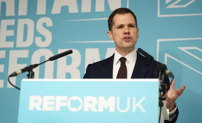 Robert Jenrick speaking at a Reform UK press conference in Westminster, London, where it was announced the former Conservative MP has joined Reform UK, Thursday, Jan. 15, 2026. (Jordan Pettitt/PA via AP)