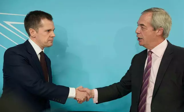 Robert Jenrick with Reform UK leader Nigel Farage at a Reform UK press conference in Westminster, London, where it was announced the former Conservative MP has joined Reform UK, Thursday, Jan. 15, 2026. (Jordan Pettitt/PA via AP)