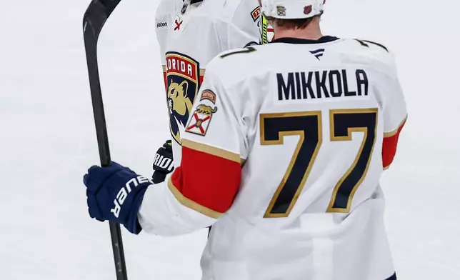 Florida Panthers' Sam Bennett (9) and Niko Mikkola (77) celebrate after Bennett's goal against the Winnipeg Jets during second-period NHL hockey game action in Winnipeg, Manitoba, Thursday, Jan. 22, 2026. (John Woods/The Canadian Press via AP)