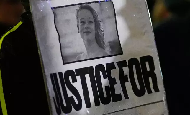 Anna Donigan protests during a rally for Renee Good, who was fatally shot by an ICE officer in Minneapolis the day before, Thursday, Jan. 8, 2026, in Kansas City, Mo. (AP Photo/Charlie Riedel)