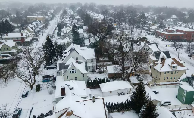 Snow covers houses in Rutherford, N.J., on Sunday, Jan. 25, 2026. (AP Photo/Ted Shaffrey)
