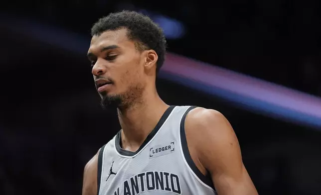 San Antonio Spurs forward Victor Wembanyama walks to the team bench during the first half of an NBA basketball game against the Minnesota Timberwolves, Sunday, Jan. 11, 2026, in Minneapolis. (AP Photo/Abbie Parr)