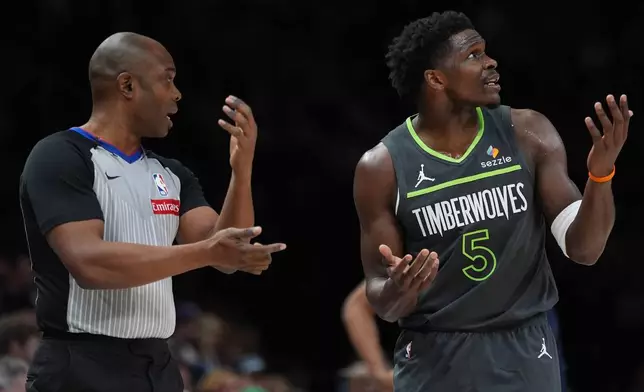 Minnesota Timberwolves guard Anthony Edwards (5) reacts next to referee Courtney Kirkland during the first half of an NBA basketball game against the San Antonio Spurs, Sunday, Jan. 11, 2026, in Minneapolis. (AP Photo/Abbie Parr)