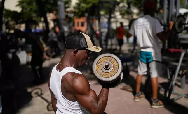A man works out at a public park in the La Candelaria neighborhood of Caracas, Venezuela, Tuesday, Jan. 6, 2026. (AP Photo/Matias Delacroix)