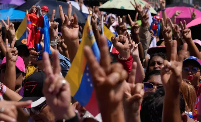 Government supporters gather for a women's march to demand the return of Venezuelan President Nicolas Maduro in Caracas, Venezuela, Tuesday, Jan. 6, 2026, three days after U.S. forces captured him and his wife. (AP Photo/Matias Delacroix)