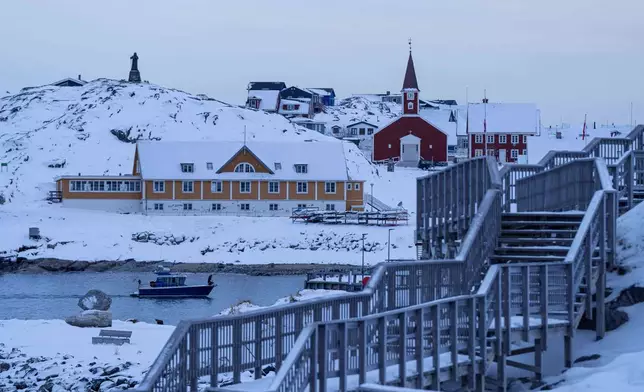 A boat travels at the sea inlet in Nuuk, Greenland, on Tuesday, Jan. 13, 2026. (AP Photo/Evgeniy Maloletka)