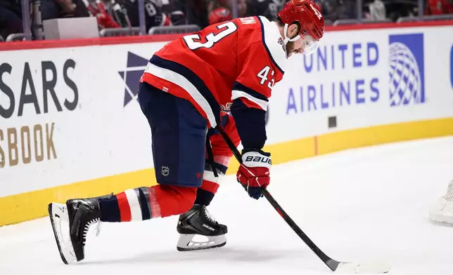 Washington Capitals right wing Tom Wilson (43) grimaces and is slow to get up after being injured during the first period of an NHL hockey game against the Chicago Blackhawks, Saturday, Jan. 3, 2026, in Washington. (AP Photo/Nick Wass)