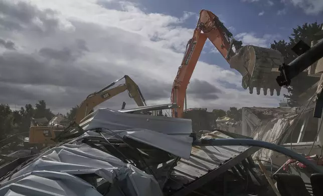Israeli bulldozers demolish a UNRWA compound, belonging to the U.N. agency that assists Palestinian refugees, in east Jerusalem Tuesday, Jan. 20, 2026. (AP Photo/Mahmoud Illean)