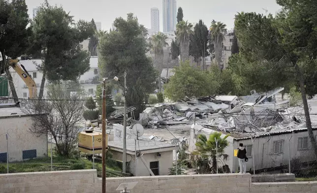 Israeli bulldozers demolish a UNRWA compound, belonging to the U.N. agency that assists Palestinian refugees, in east Jerusalem Tuesday, Jan. 20, 2026. (AP Photo/Mahmoud Illean)