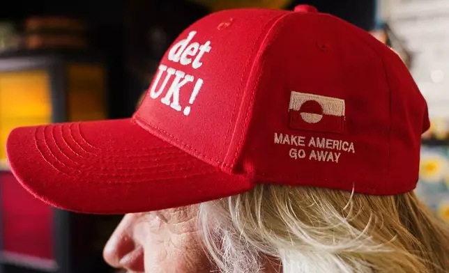 Store owner Jesper Rabe Tonnesen wears a red cap for sale that he created with the slogans "Make America go away," on the side, and on the front: "Nu det NUUK!," a twist on the Danish phrase “Nu det nok,” meaning “Now it’s enough,” substituting Nuuk, Greenland’s tiny capital, in Copenhagen, Denmark, Thursday, Jan. 15, 2026. (AP Photo/James Brooks)