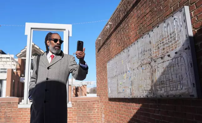 Attorney Michael Coard makes a social media post at the now removed explanatory panels that were part of an exhibit on slavery at President's House Site in Philadelphia, Friday, Jan. 30, 2026. (AP Photo/Matt Rourke)