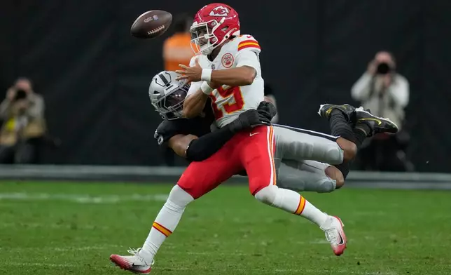 Kansas City Chiefs quarterback Chris Oladokun (19) fumbles as he is sacked for an 8-yard loss by Las Vegas Raiders defensive end Tyree Wilson during the first half of an NFL football game Sunday, Jan. 4, 2026, in Las Vegas. (AP Photo/John Locher)