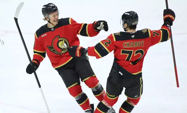 Ottawa Senators' Fabian Zetterlund, left, celebrates after his goal with Thomas Chabot (72) during first-period NHL hockey game action in Ottawa, Ontario, Saturday, Jan. 10, 2026. (Patrick Doyle/The Canadian Press via AP)